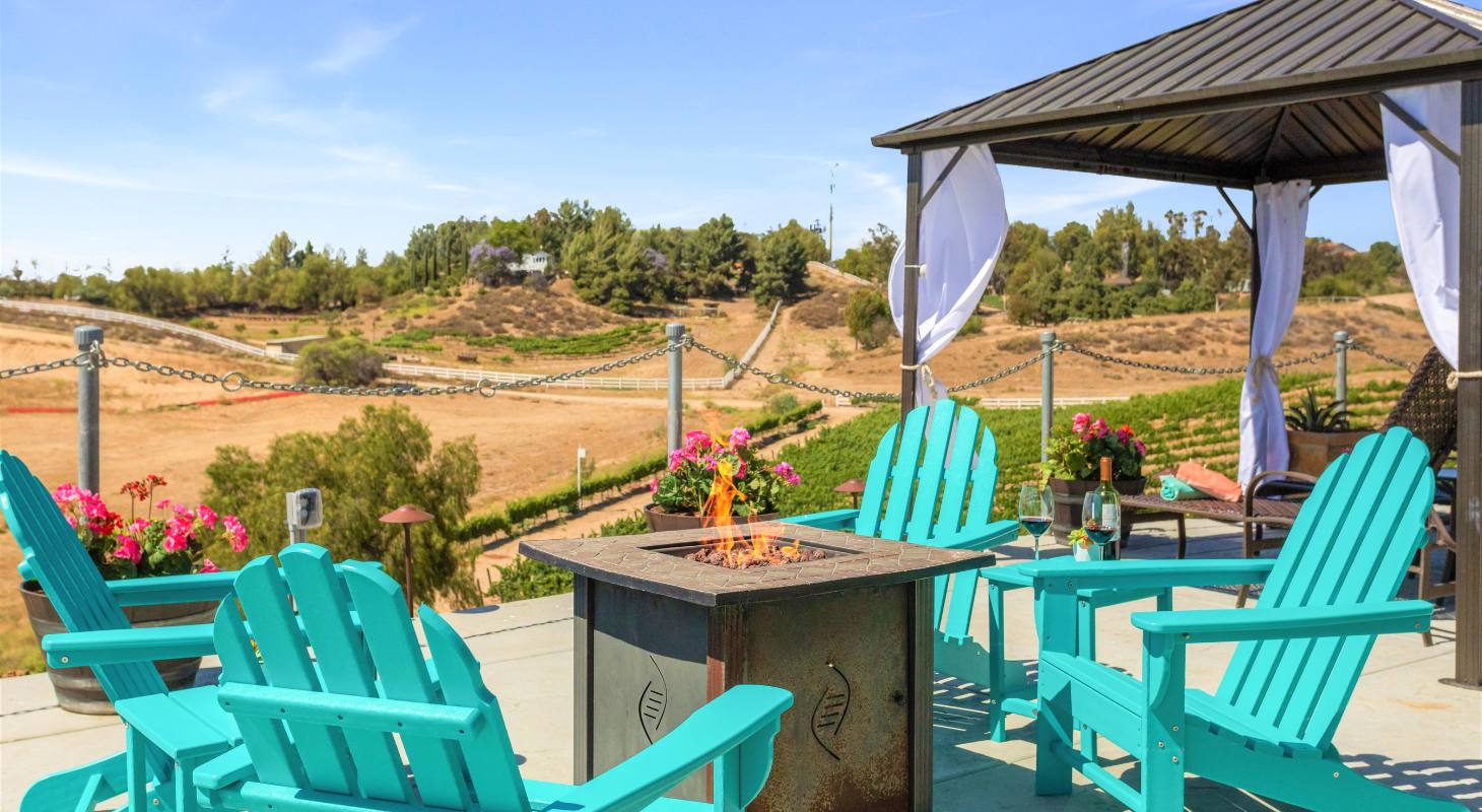 Fireplace with chairs around it at Temecula Inns
