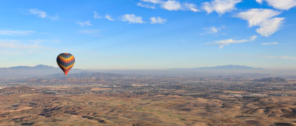 Hot air balloon flying above a vineyard at the Temecula Valley Balloon and Wine Festival